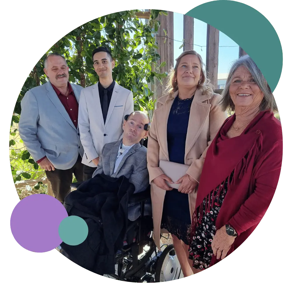 A disabled man sitting in his wheelchair and his group of friends