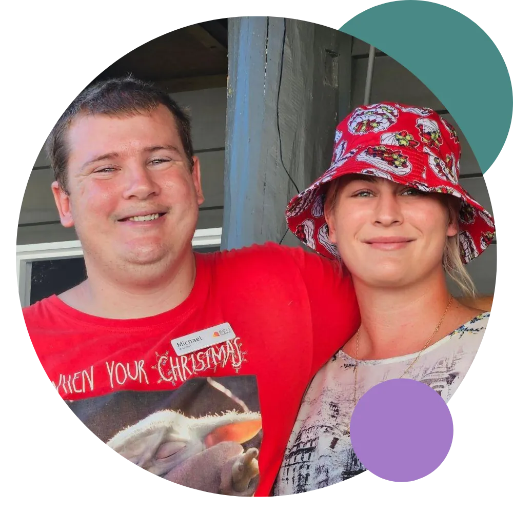 Owner, Sharon, smiling at camera with another man